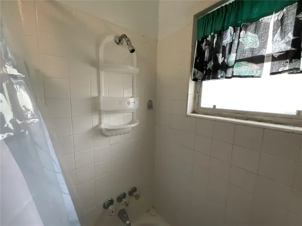 a bathroom with a bathtub and shower