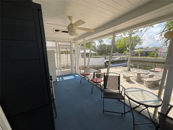 a dining room with furniture and a floor to ceiling window