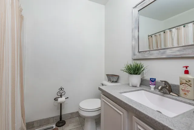 a bathroom with a sink toilet and a mirror