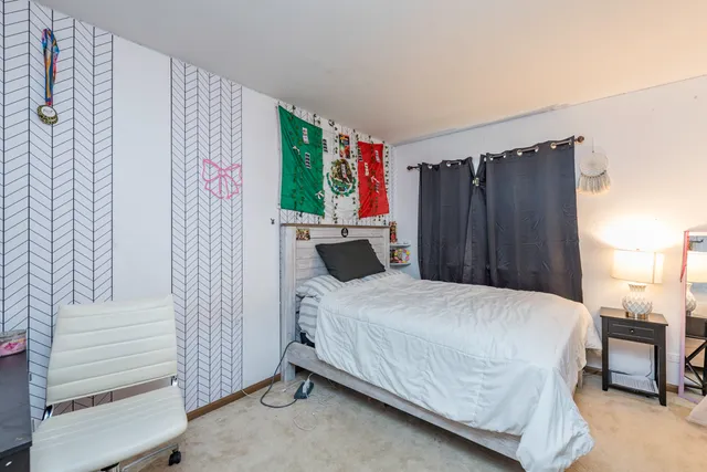 a bedroom with a bed and a table