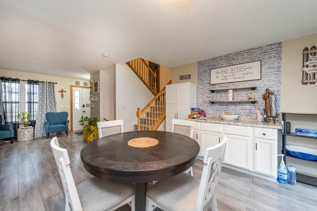 a kitchen with a dining table and chairs