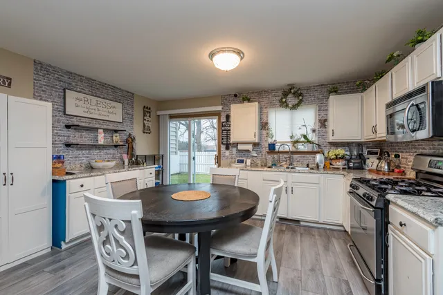 a kitchen with a table and chairs in it