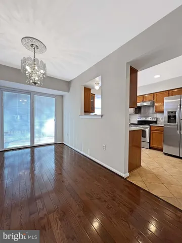 a view of a kitchen with a sink wooden floor and a large window