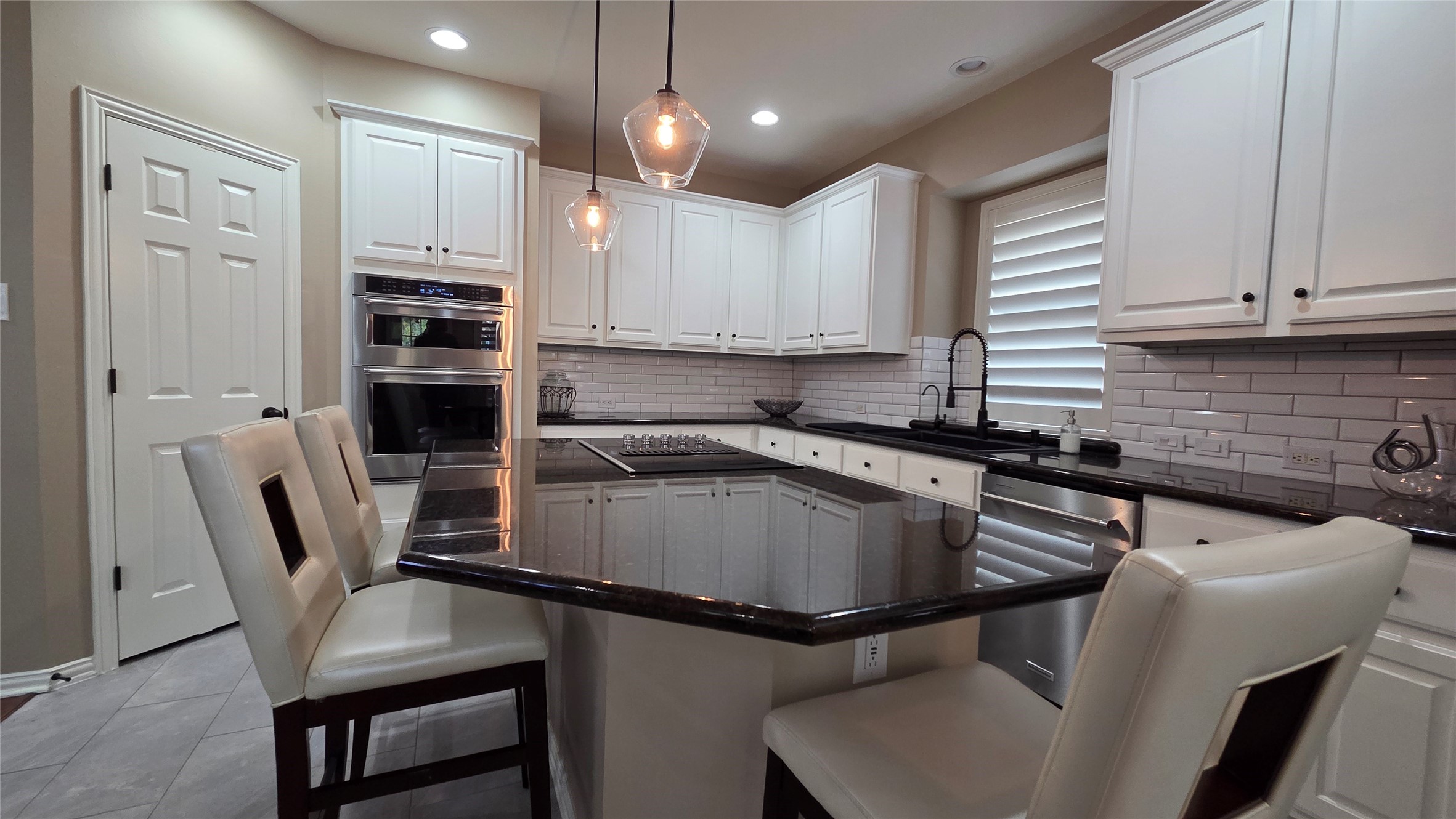 10310 Pitcataway Drive Spring, TX 77379 - Photo 15 of 37 a kitchen with kitchen island a appliances dining table chairs cabinets