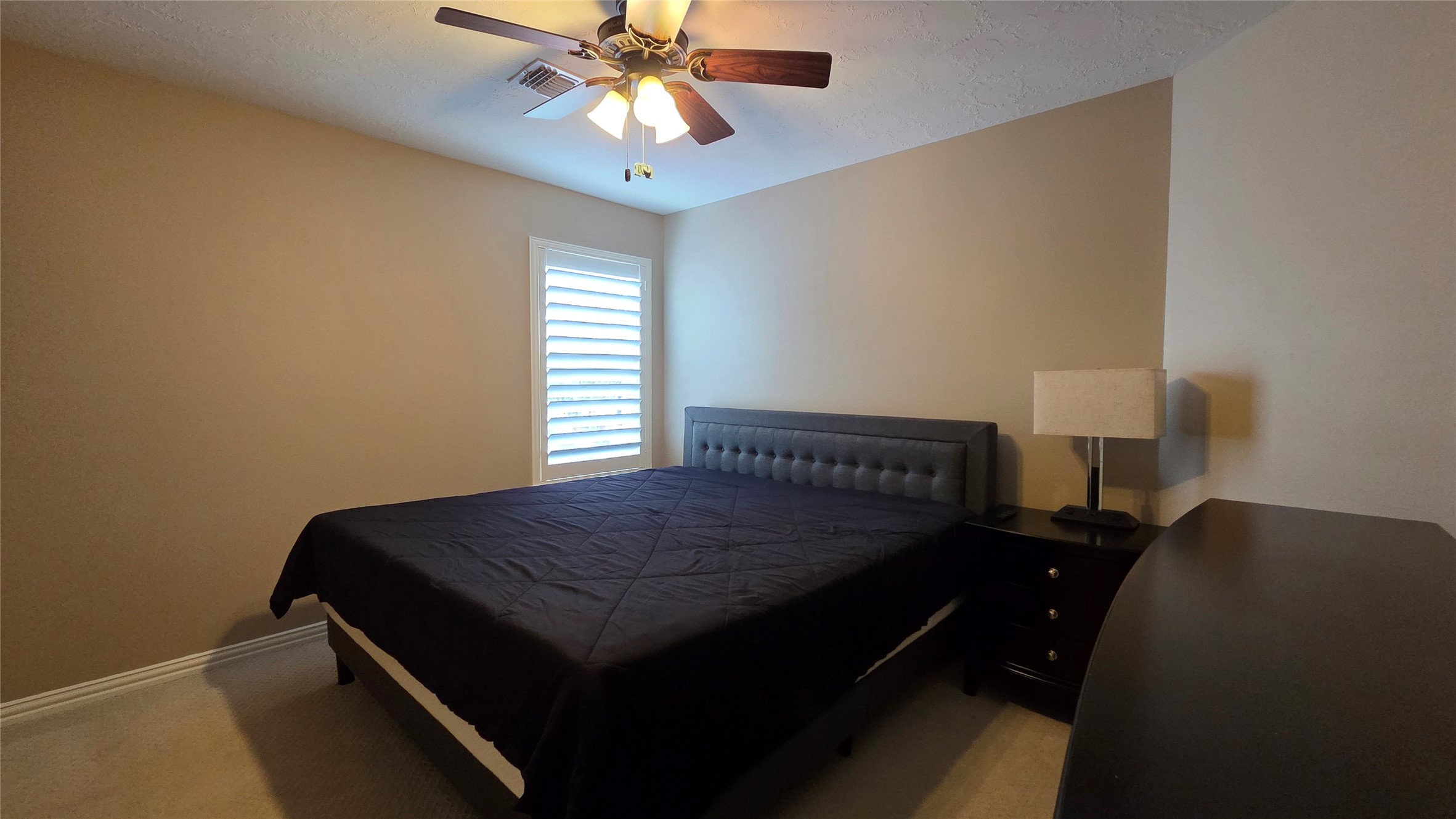 10310 Pitcataway Drive Spring, TX 77379 - Photo 28 of 37 a bedroom with a bed and a chandelier