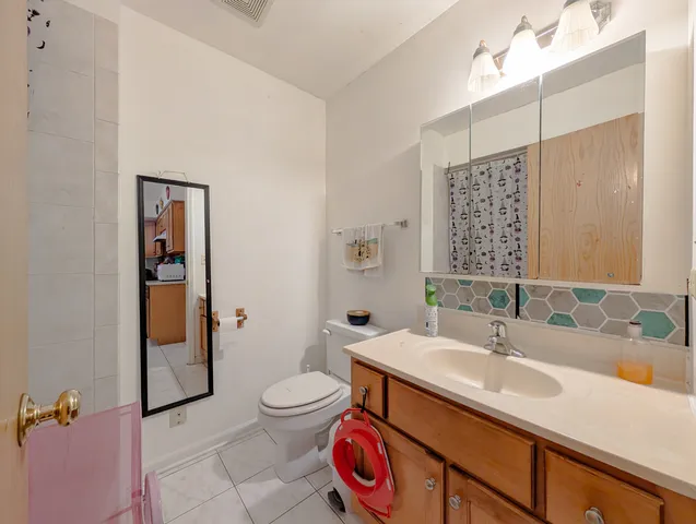 a bathroom with a toilet and a shower curtain