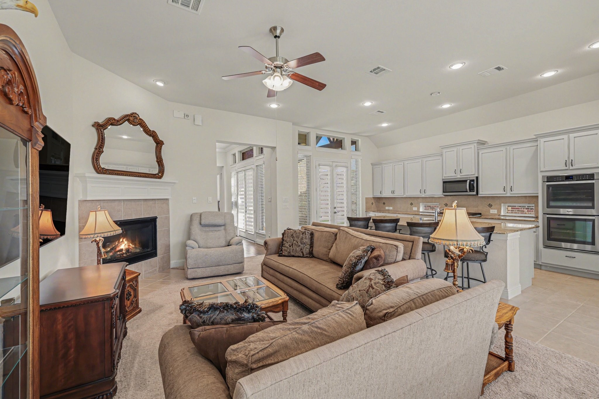 7434 Kearney Hill Lane Spring, TX 77389 - Photo 13 of 36 a living room with furniture kitchen and a fireplace
