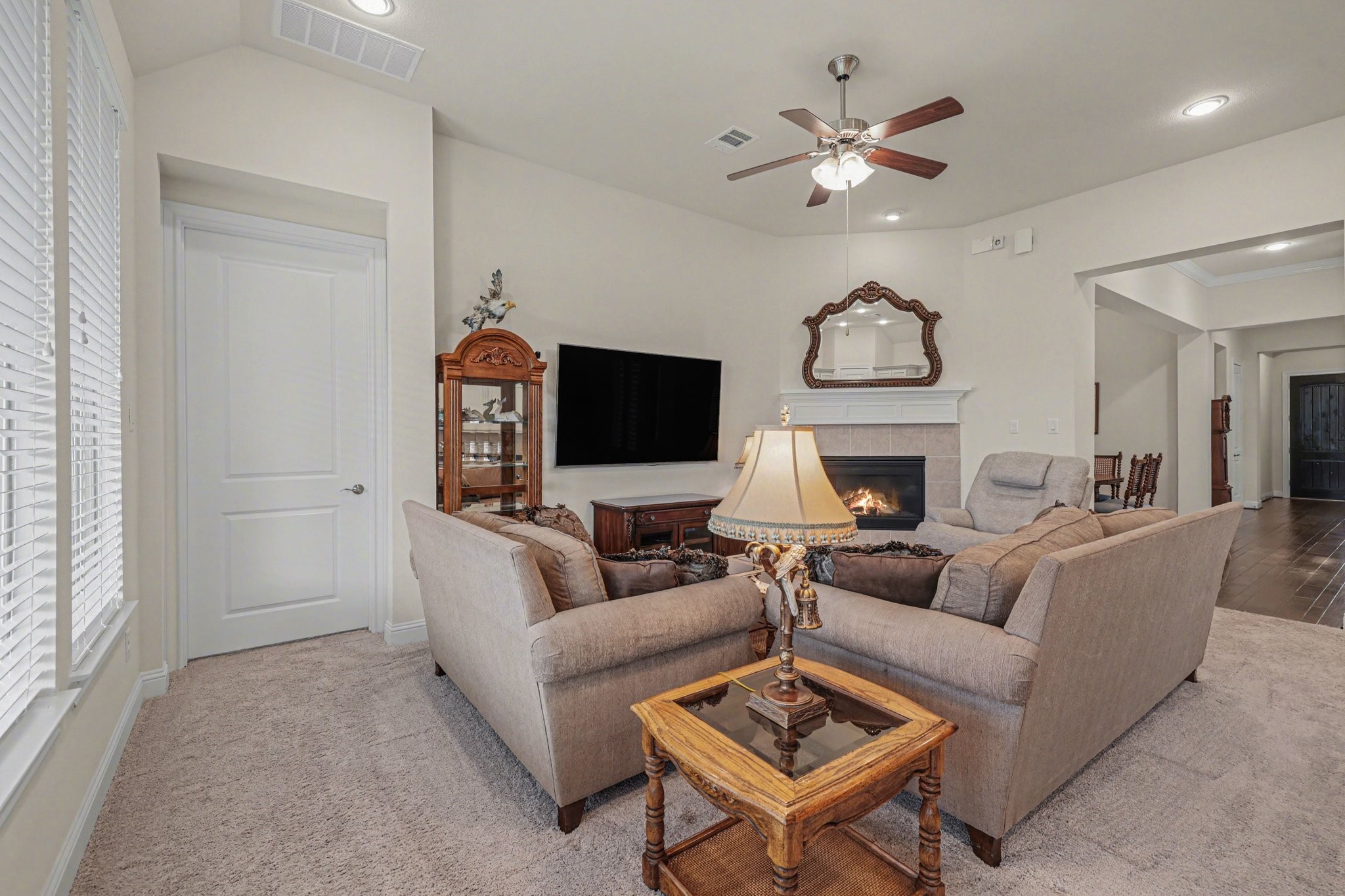 7434 Kearney Hill Lane Spring, TX 77389 - Photo 14 of 36 a living room with furniture a fireplace and a flat screen tv