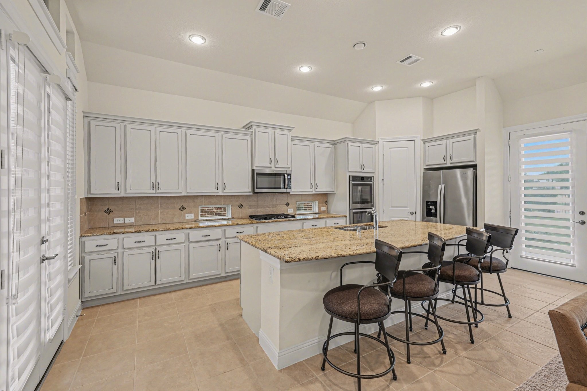 7434 Kearney Hill Lane Spring, TX 77389 - Photo 7 of 36 a kitchen with stainless steel appliances granite countertop a table and chairs in it