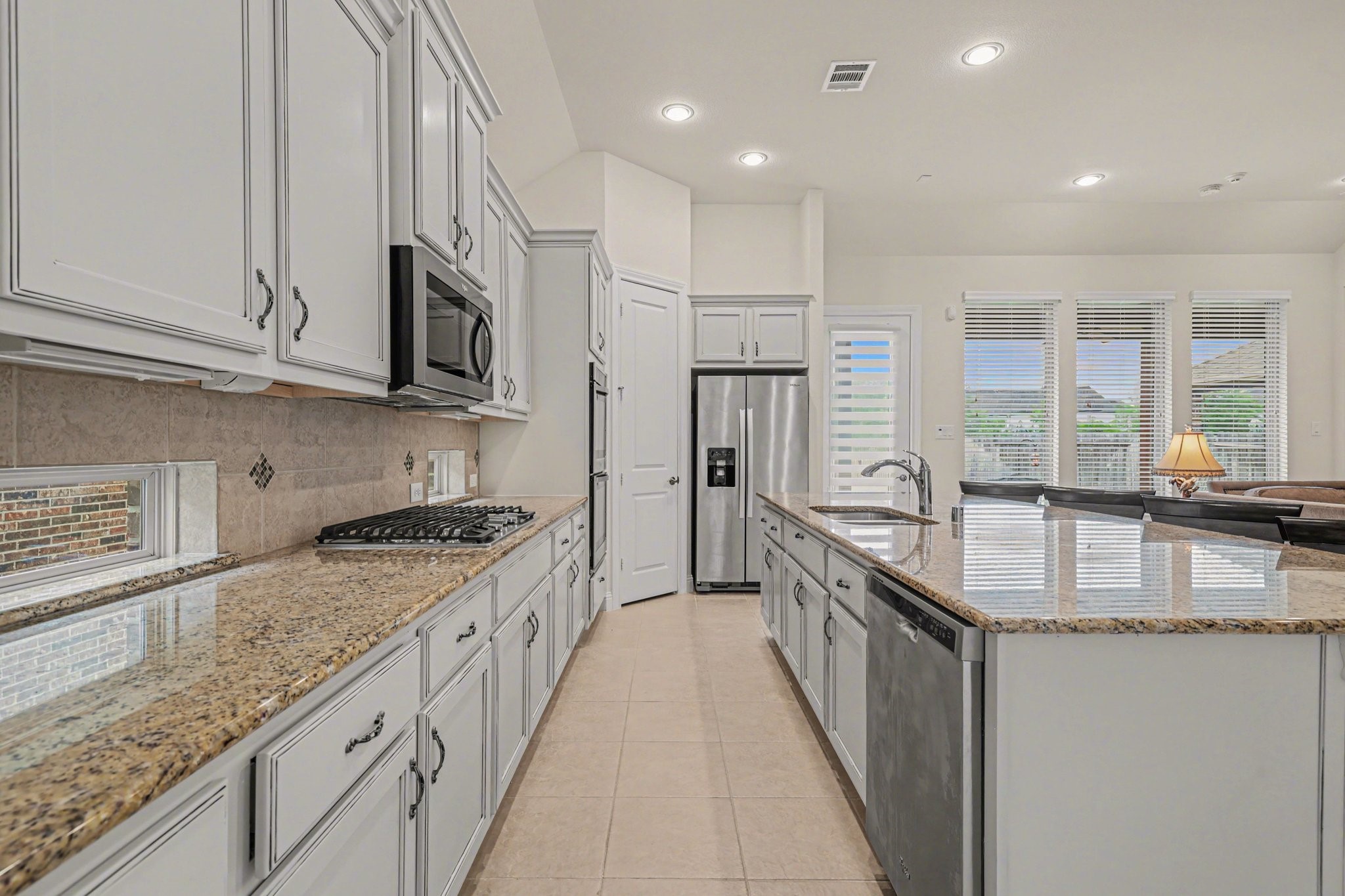 7434 Kearney Hill Lane Spring, TX 77389 - Photo 8 of 36 a kitchen with granite countertop a sink a counter top space stainless steel appliances and cabinets