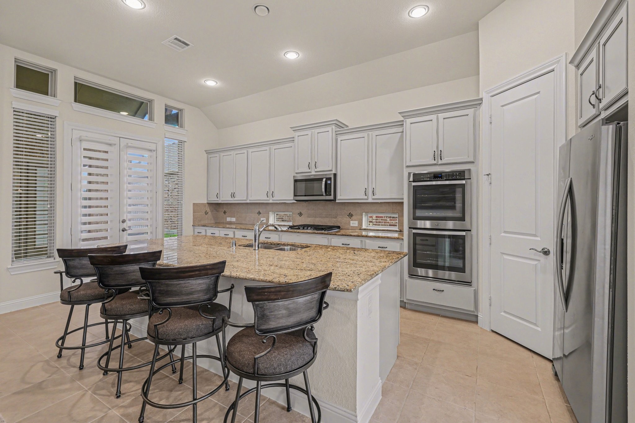 7434 Kearney Hill Lane Spring, TX 77389 - Photo 9 of 36 a kitchen with stainless steel appliances granite countertop a stove a sink a microwave and a refrigerator