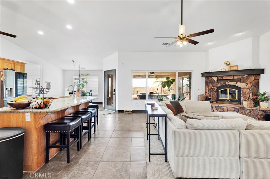 13724 Yuma Road Apple Valley, CA 92307 - Photo 13 of 75 a living room with furniture a fireplace and a window