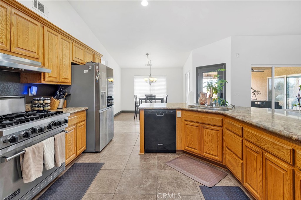 13724 Yuma Road Apple Valley, CA 92307 - Photo 19 of 75 a large kitchen with stainless steel appliances granite countertop a stove a sink dishwasher and a refrigerator