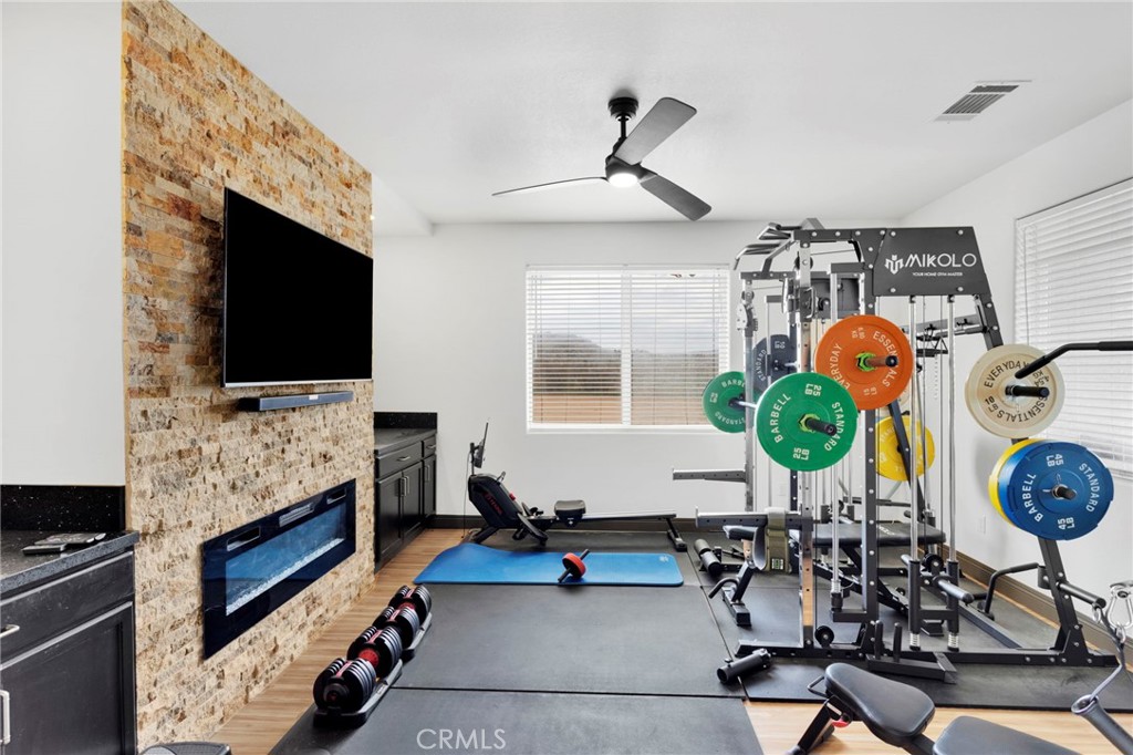 13724 Yuma Road Apple Valley, CA 92307 - Photo 24 of 75 a living room with furniture a flat screen tv and a fireplace