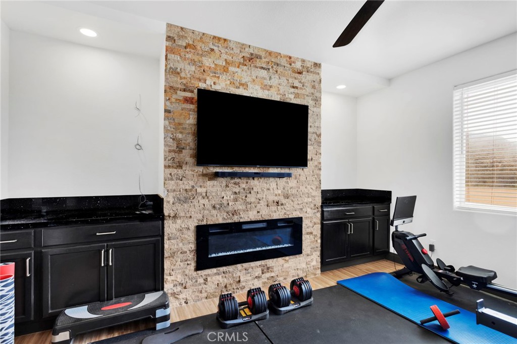 13724 Yuma Road Apple Valley, CA 92307 - Photo 25 of 75 a living room with furniture a flat screen tv and a fireplace