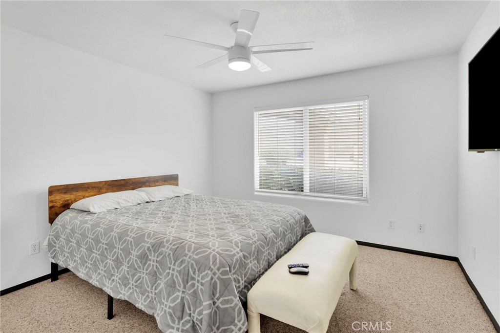 13724 Yuma Road Apple Valley, CA 92307 - Photo 27 of 75 a bedroom with a bed and a window