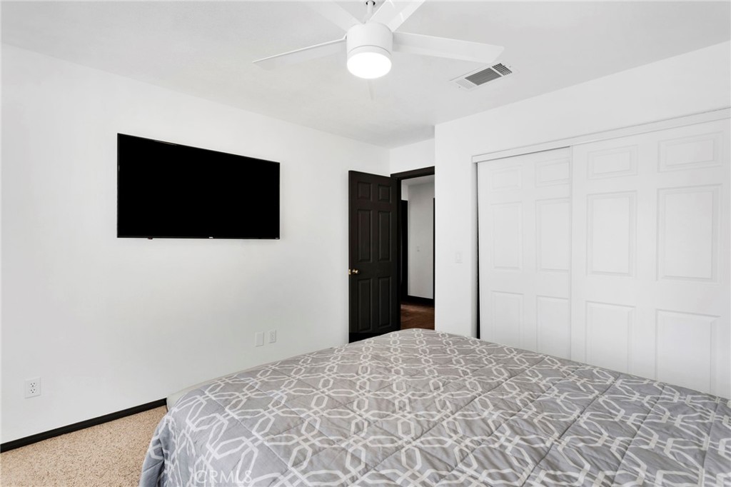 13724 Yuma Road Apple Valley, CA 92307 - Photo 28 of 75 a bedroom with a bed and a flat screen tv