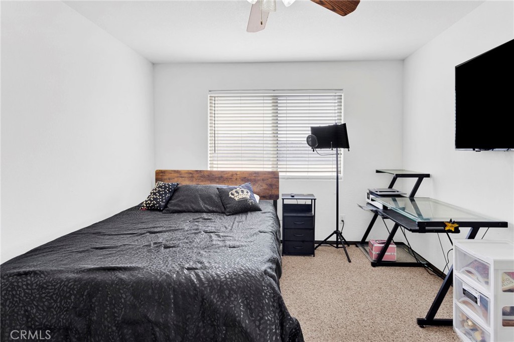 13724 Yuma Road Apple Valley, CA 92307 - Photo 32 of 75 a bedroom with a bed and a flat screen tv