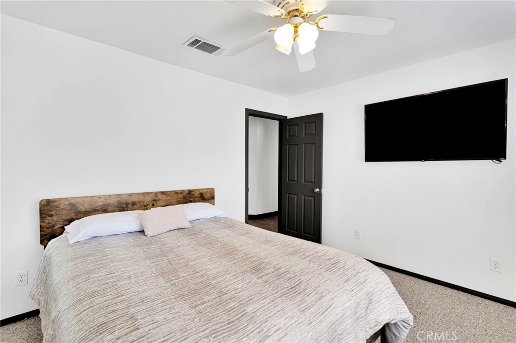 13724 Yuma Road Apple Valley, CA 92307 - Photo 34 of 75 a bedroom with a bed and a flat screen tv