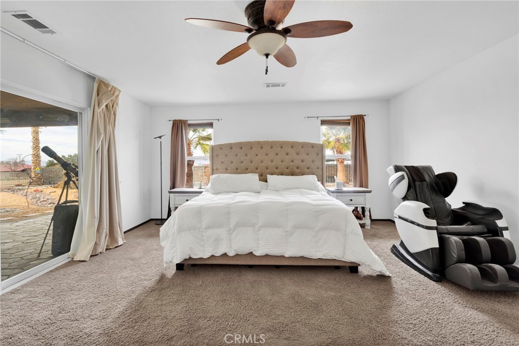 13724 Yuma Road Apple Valley, CA 92307 - Photo 35 of 75 a bedroom with a bed and ceiling fan