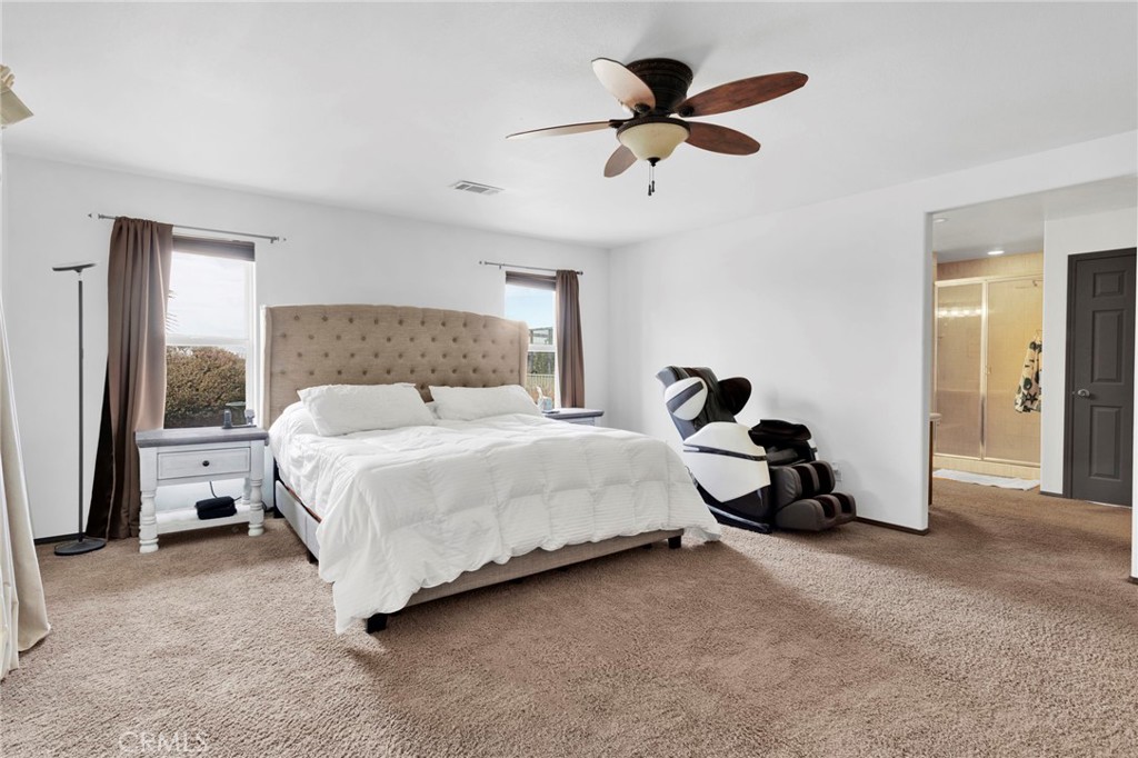 13724 Yuma Road Apple Valley, CA 92307 - Photo 36 of 75 a bedroom with a bed and a ceiling fan