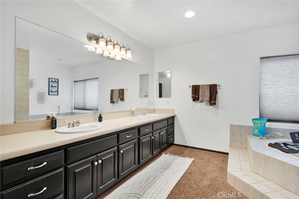 13724 Yuma Road Apple Valley, CA 92307 - Photo 38 of 75 a spacious bathroom with a double vanity sink and a mirror