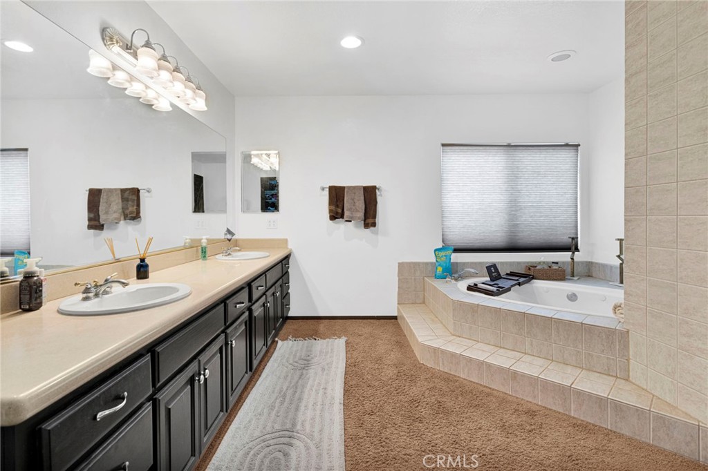 13724 Yuma Road Apple Valley, CA 92307 - Photo 39 of 75 a spacious bathroom with a double vanity sink a mirror and a bathtub