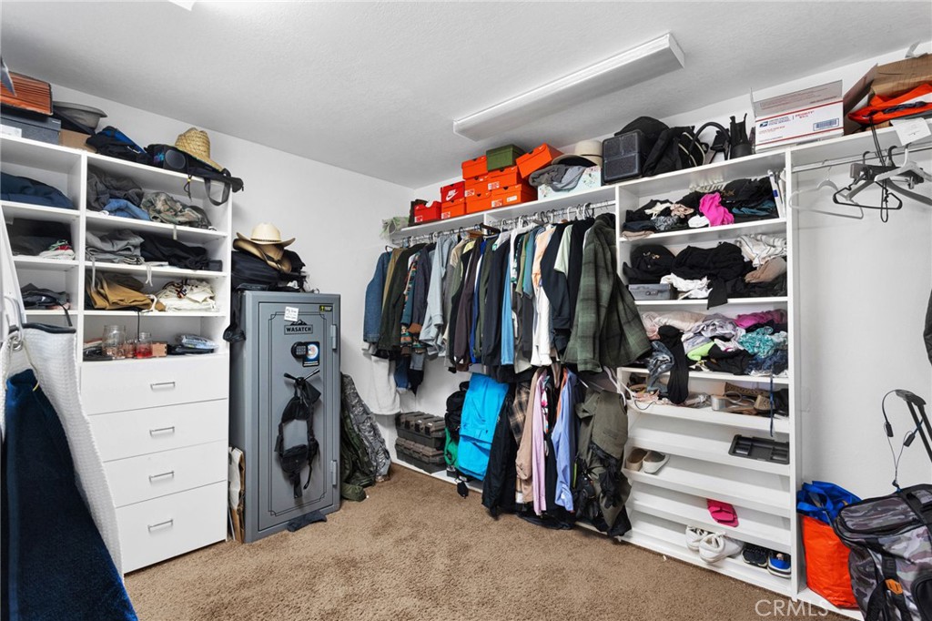 13724 Yuma Road Apple Valley, CA 92307 - Photo 41 of 75 a view of walk in closet with clothes and shoes