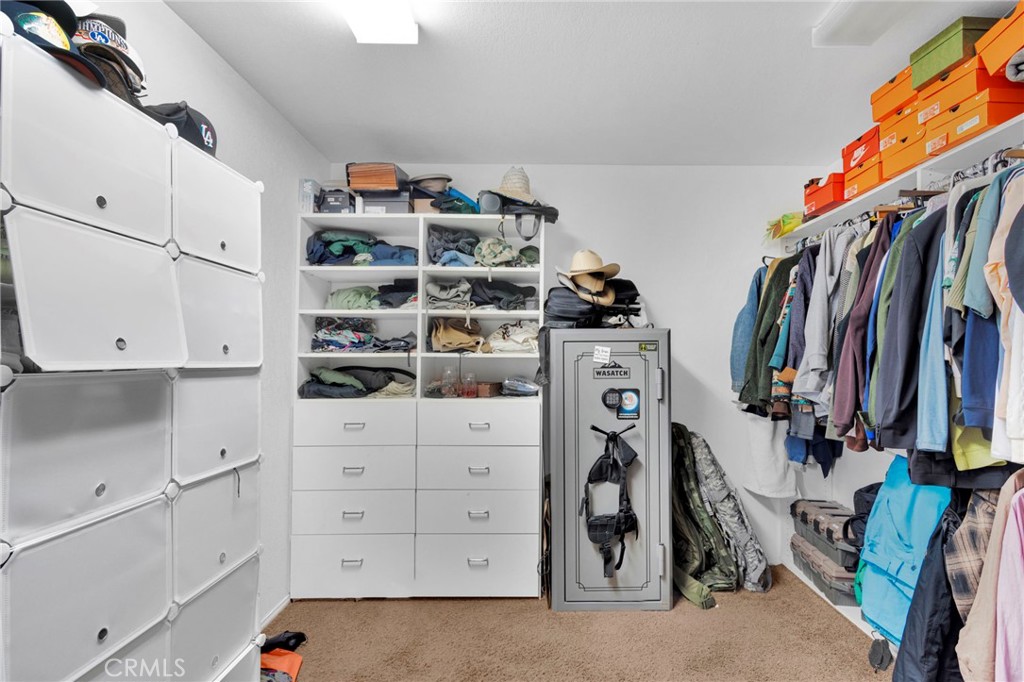 13724 Yuma Road Apple Valley, CA 92307 - Photo 42 of 75 a view of walk in closet with clothes and shoes