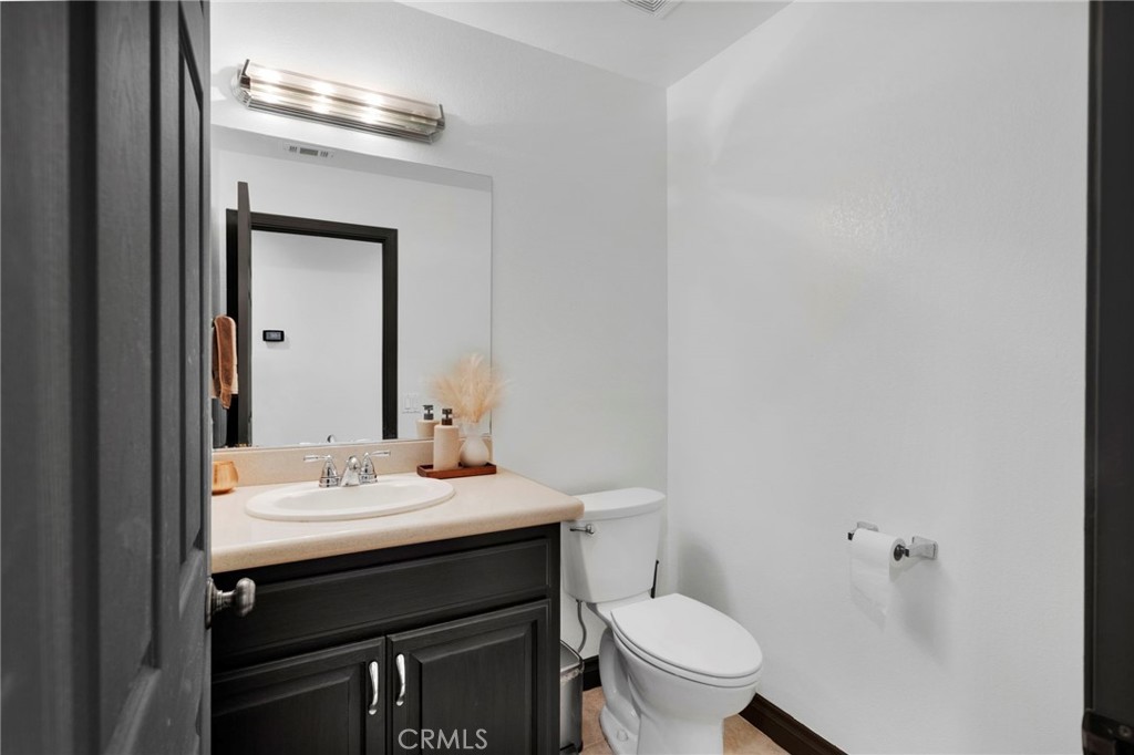 13724 Yuma Road Apple Valley, CA 92307 - Photo 45 of 75 a bathroom with a sink vanity and a toilet