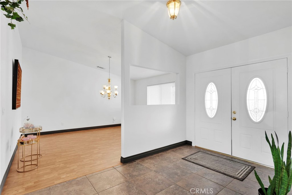 13724 Yuma Road Apple Valley, CA 92307 - Photo 9 of 75 a view of a room with wooden floor and a potted plant