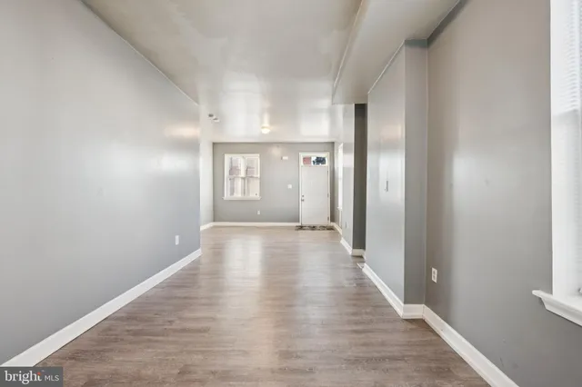 a view of a hallway with wooden floor