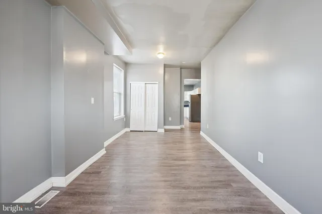 a view of hallway with wooden floor