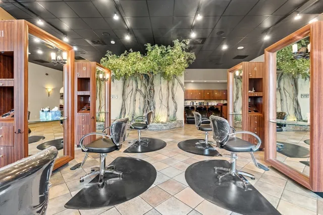 a very nice looking dining room with stainless steel appliances kitchen island granite countertop a table and chairs