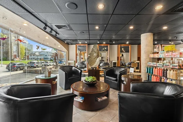 a living room with lots of furniture and a potted plant