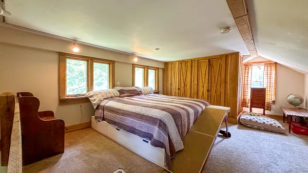 a bed room with a bed and a chair