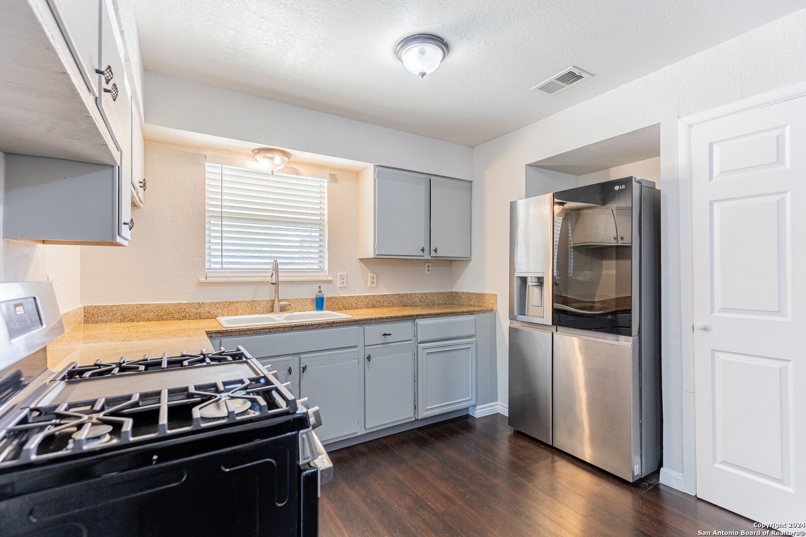 7802 Rimfire Drive San Antonio, TX 78227 - Photo 12 of 39 a kitchen with granite countertop stainless steel appliances and wooden cabinets