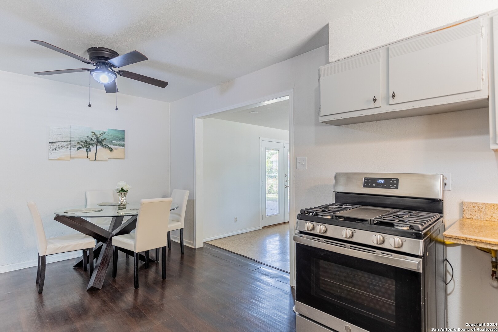 7802 Rimfire Drive San Antonio, TX 78227 - Photo 14 of 39 a kitchen with stainless steel appliances a white table and chairs in it