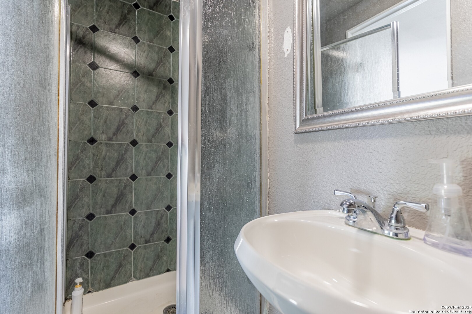 7802 Rimfire Drive San Antonio, TX 78227 - Photo 24 of 39 a bathroom with a sink and a shower