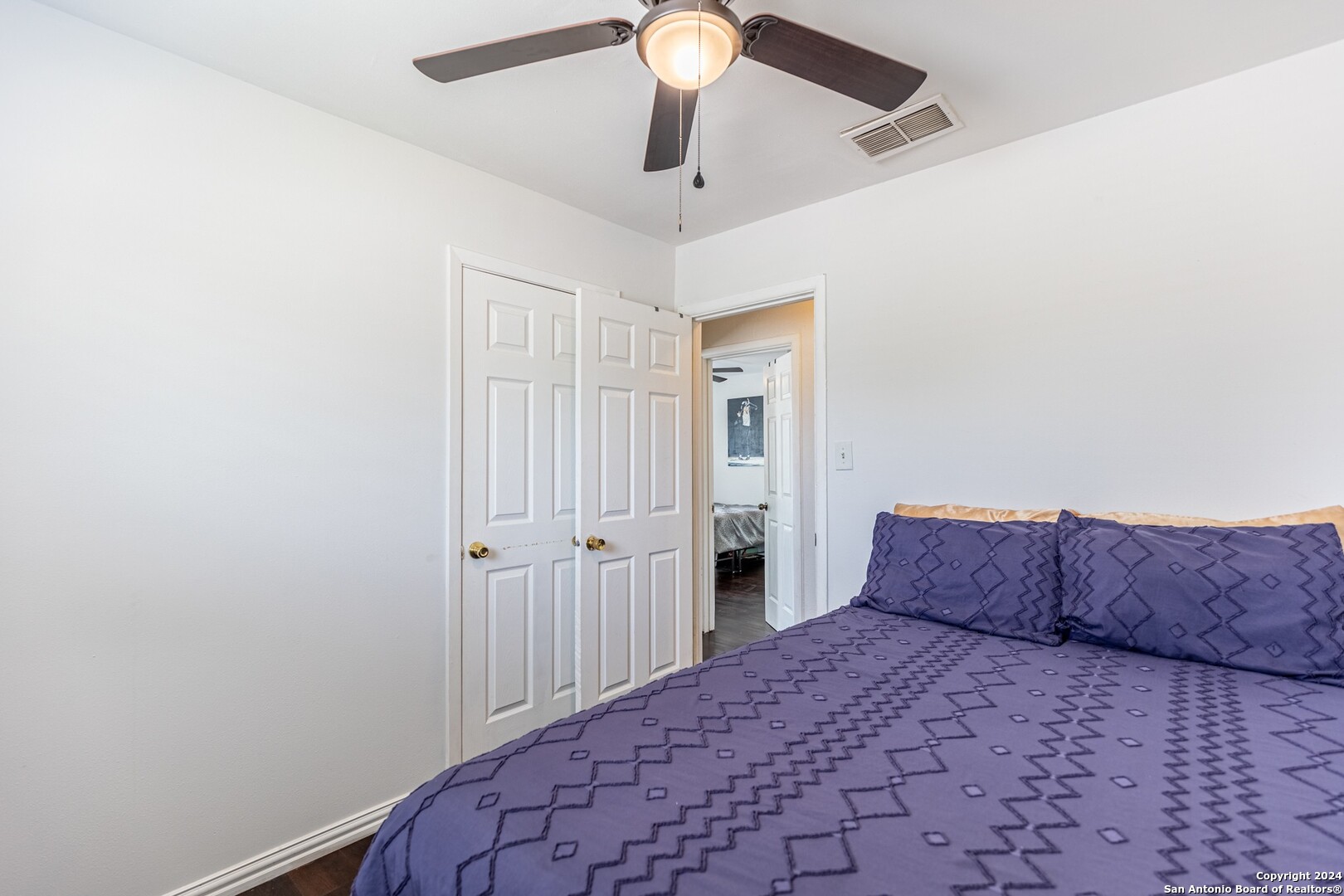 7802 Rimfire Drive San Antonio, TX 78227 - Photo 28 of 39 a bedroom with a bed and a chandelier fan