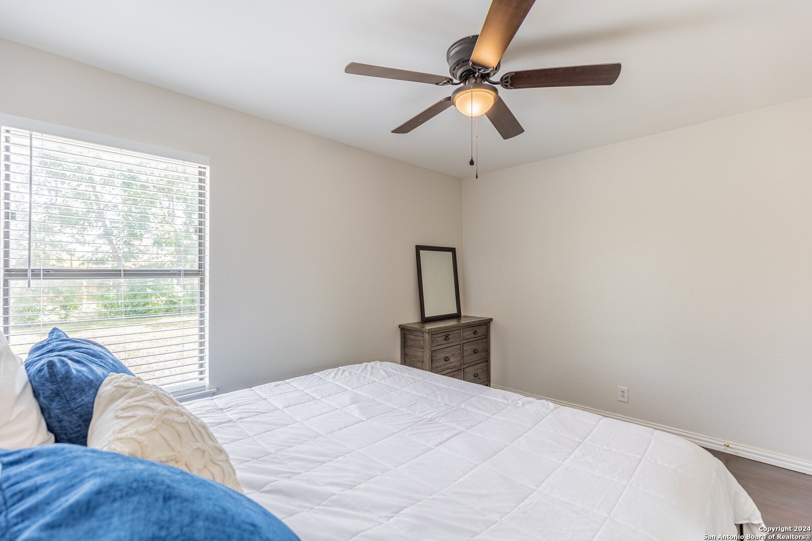 7802 Rimfire Drive San Antonio, TX 78227 - Photo 30 of 39 a bedroom with a large bed and a window