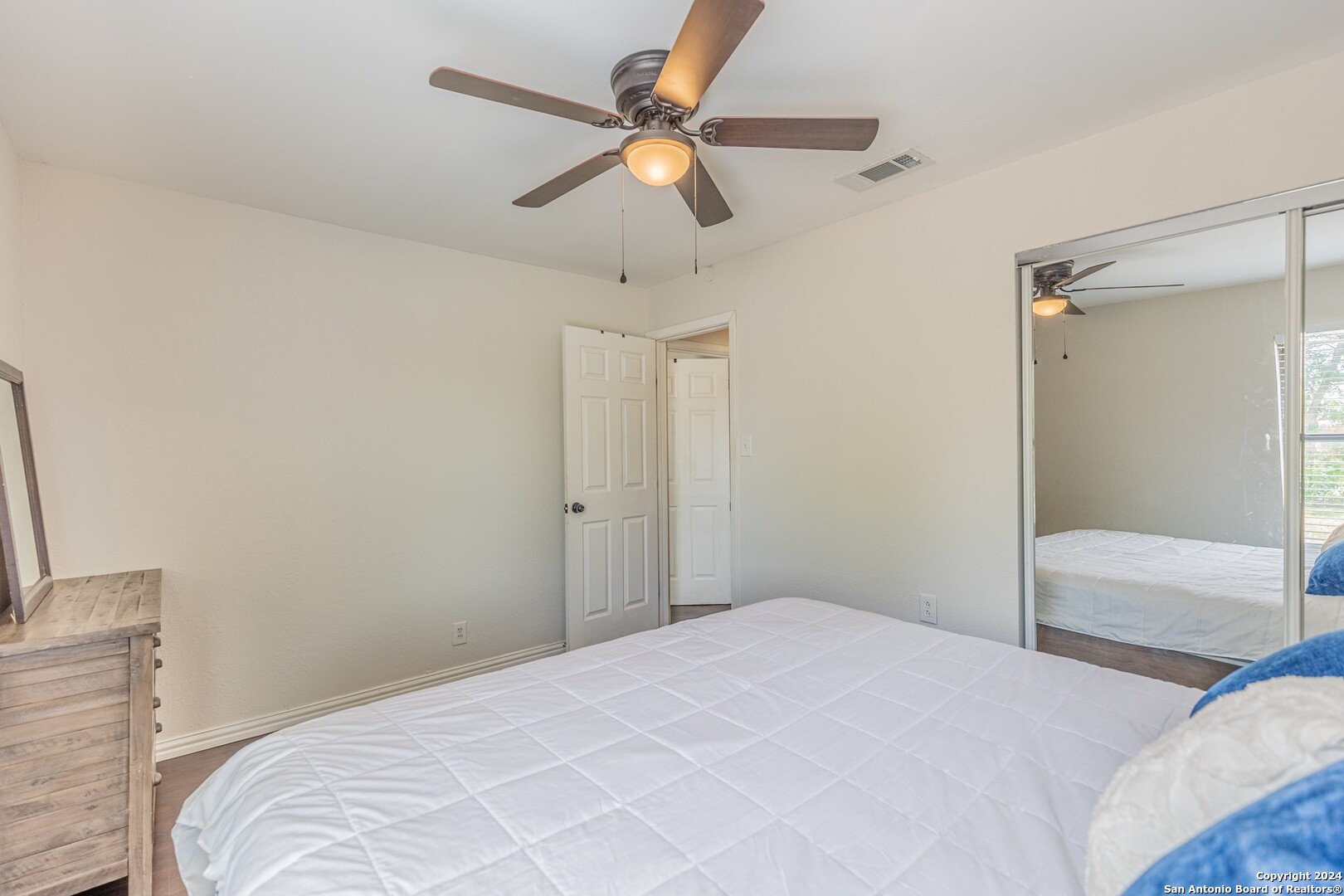 7802 Rimfire Drive San Antonio, TX 78227 - Photo 31 of 39 a bedroom with a bed and a chandelier