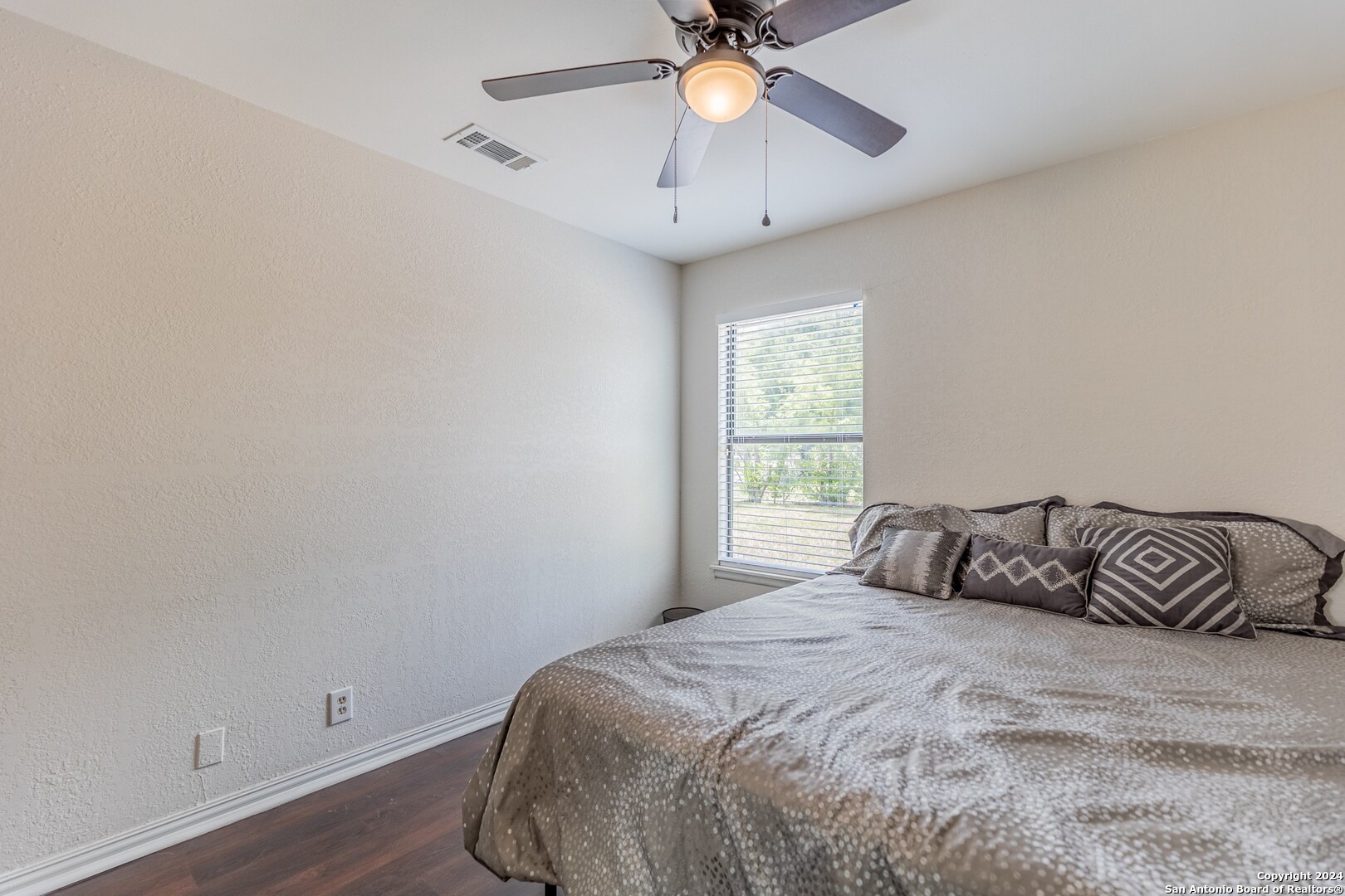 7802 Rimfire Drive San Antonio, TX 78227 - Photo 33 of 39 a bedroom with a bed and a window