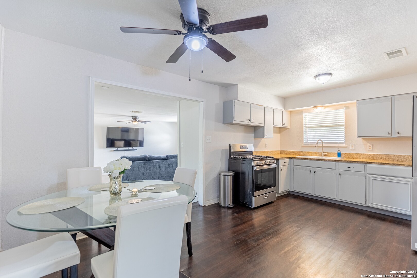 7802 Rimfire Drive San Antonio, TX 78227 - Photo 9 of 39 a kitchen with a stove a sink and a refrigerator