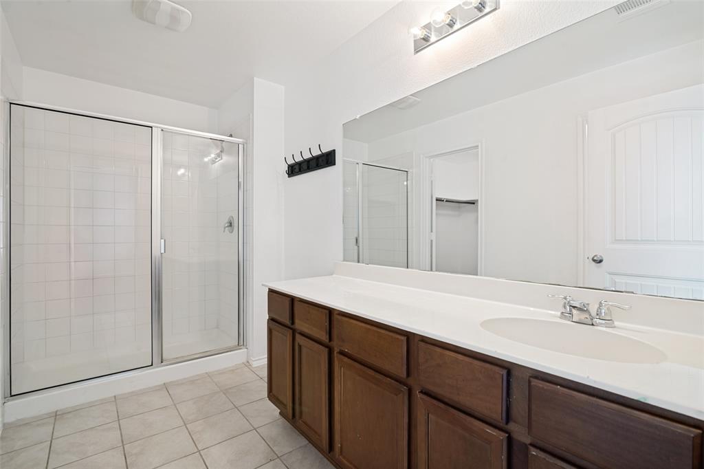 3415 Emerson Road Forney, TX 75126 - Photo 21 of 26 a bathroom with a sink and a mirror