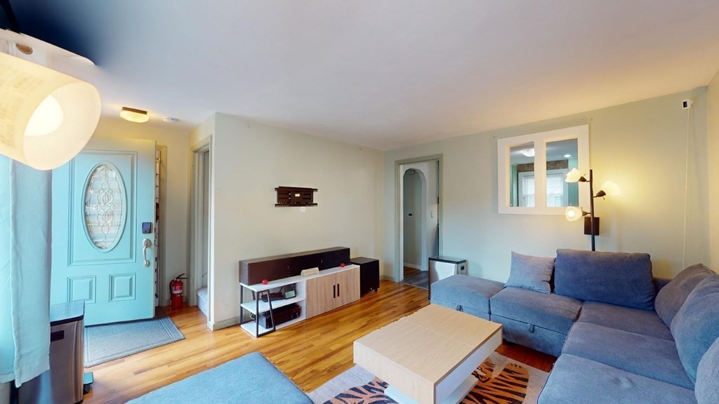 274 Cooper Street Springfield, MA 01108 - Photo 12 of 42 a living room with furniture a flat screen tv and a window