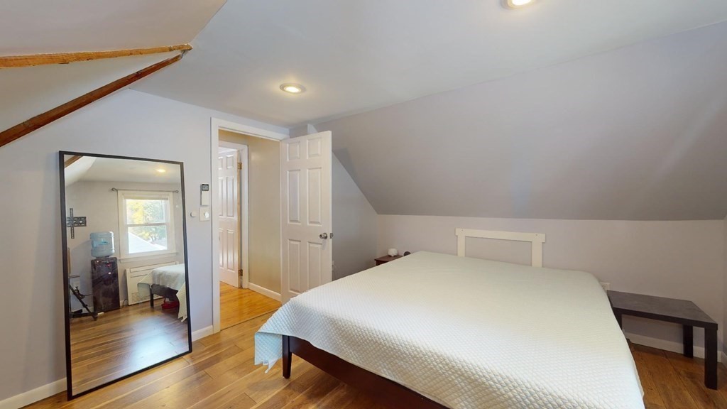 274 Cooper Street Springfield, MA 01108 - Photo 24 of 42 a bedroom with a bed and wooden floor