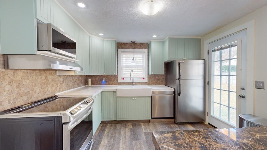 274 Cooper Street Springfield, MA 01108 - Photo 3 of 42 a kitchen with a sink a refrigerator and cabinets