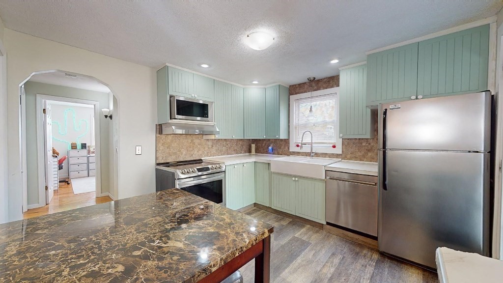 274 Cooper Street Springfield, MA 01108 - Photo 5 of 42 a kitchen with a refrigerator and a stove top oven