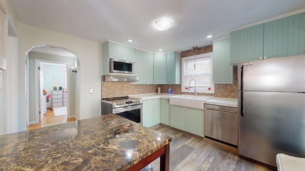 274 Cooper Street Springfield, MA 01108 - Photo 8 of 42 a kitchen with a refrigerator and a stove top oven